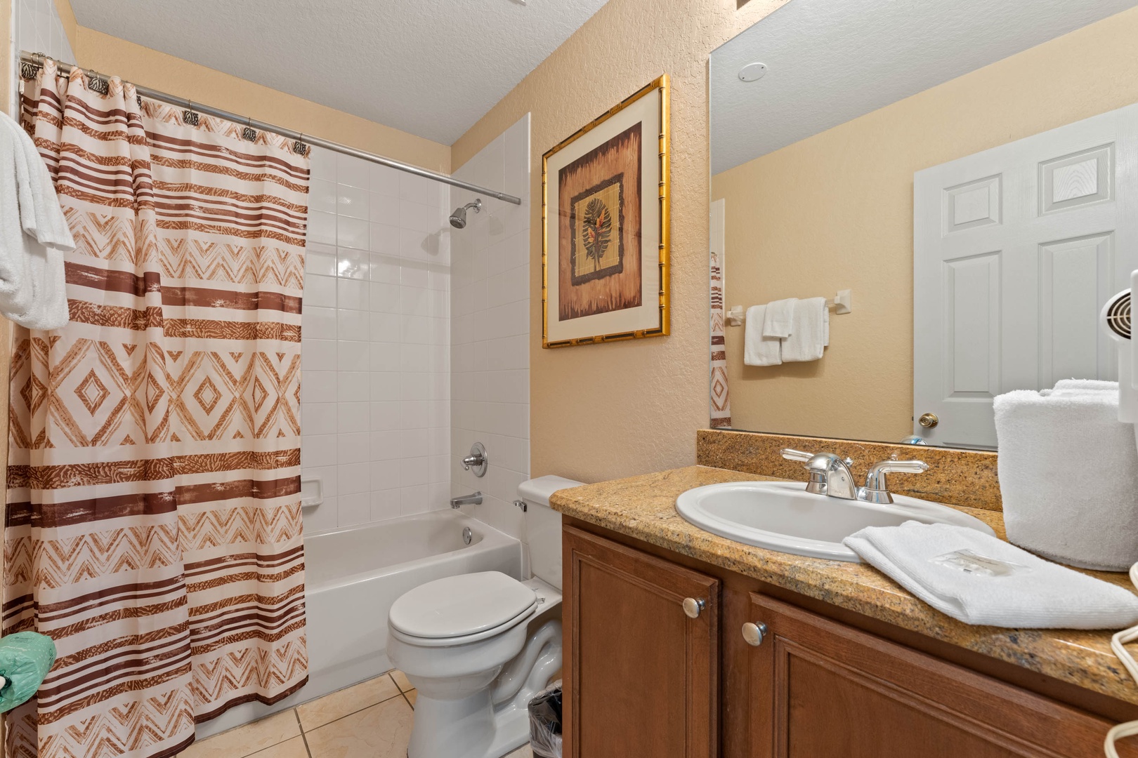The 2nd floor shared full bathroom offers a single vanity & shower/tub combo