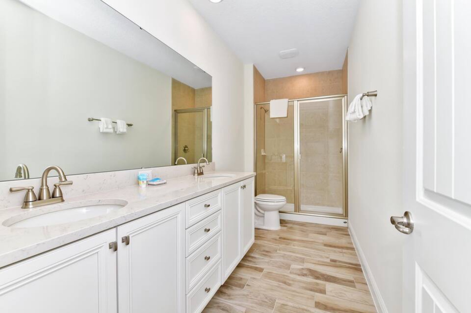 Wash up in the king ensuite, featuring a double vanity & walk-in shower