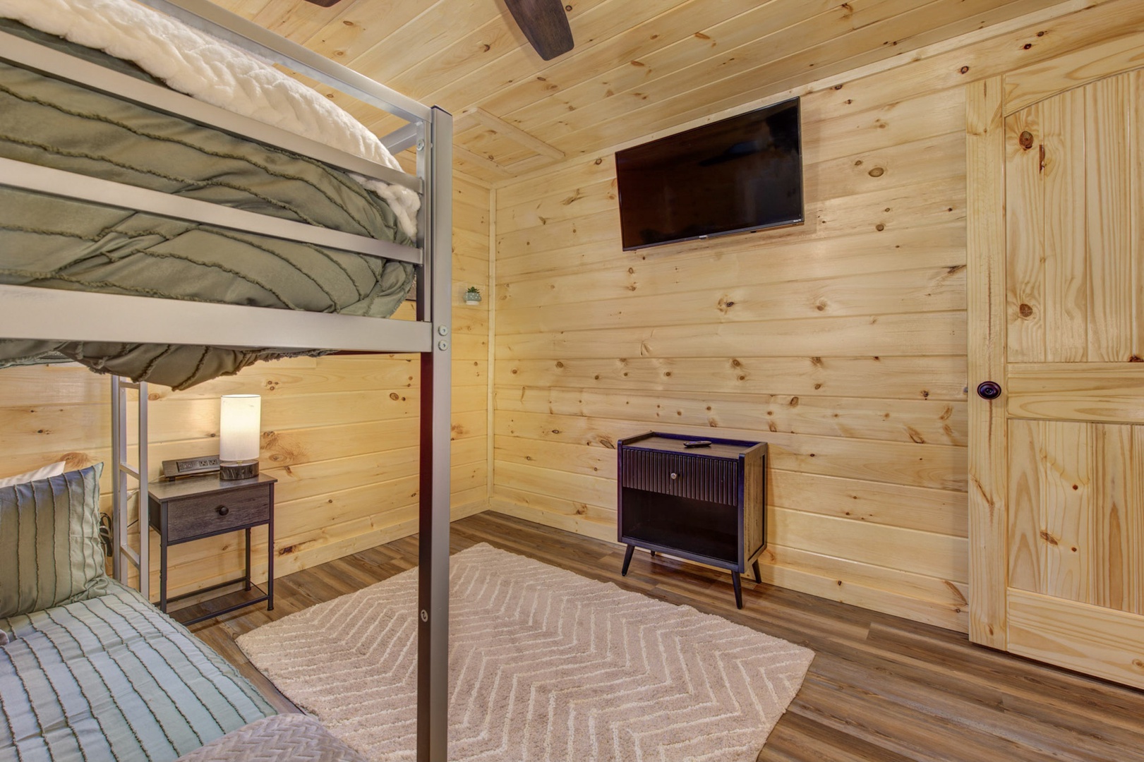 The third bedroom retreat contains a full over full bunk, TV & arcade area