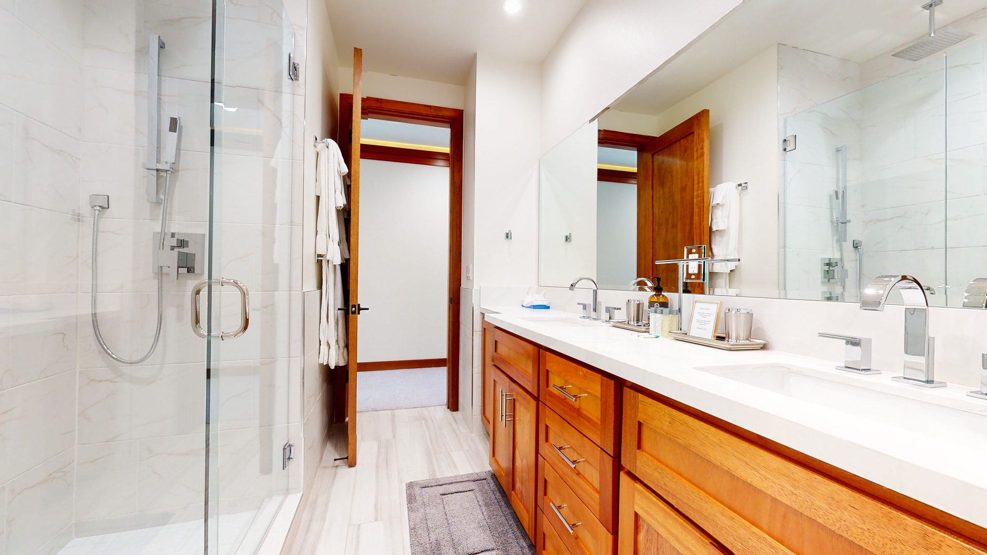 The 3rd floor hall bath offers a sprawling double vanity and gorgeous glass shower