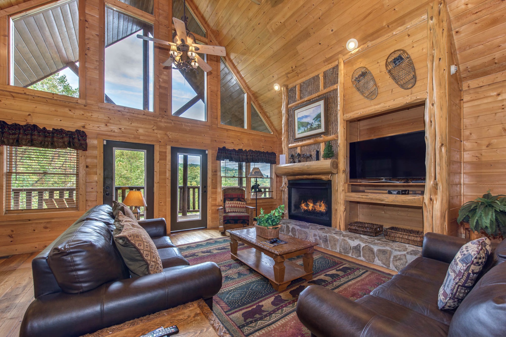 Spacious living room with ample seating, gas fireplace, Smart TV, and deck access