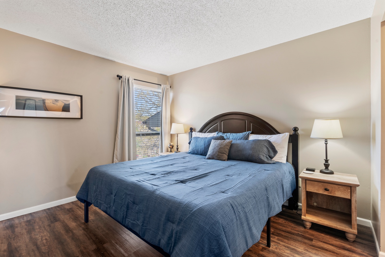 Unit 19’s tranquil primary suite boasts a plush king bed, ensuite, & TV