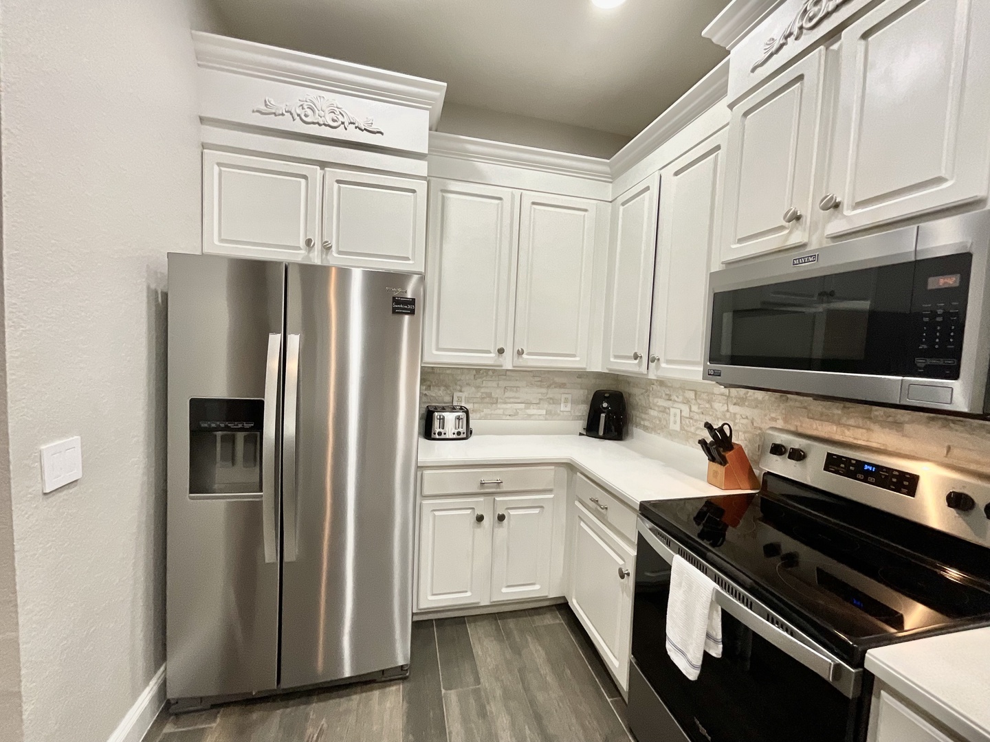 The airy kitchen provides ample space and all the comforts of home