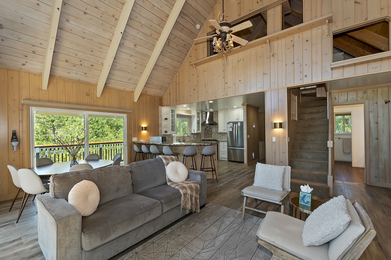 Bright living room with queen sofa sleeper, fireplace, and deck access