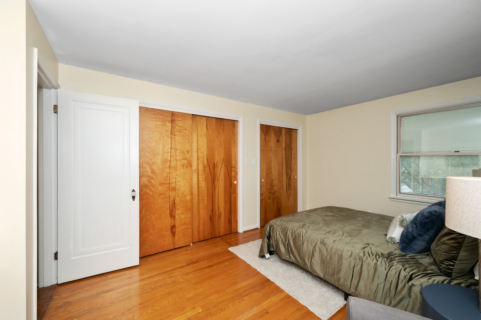 This 2nd floor bedroom offers a queen bed, desk workspace, & chic sitting area