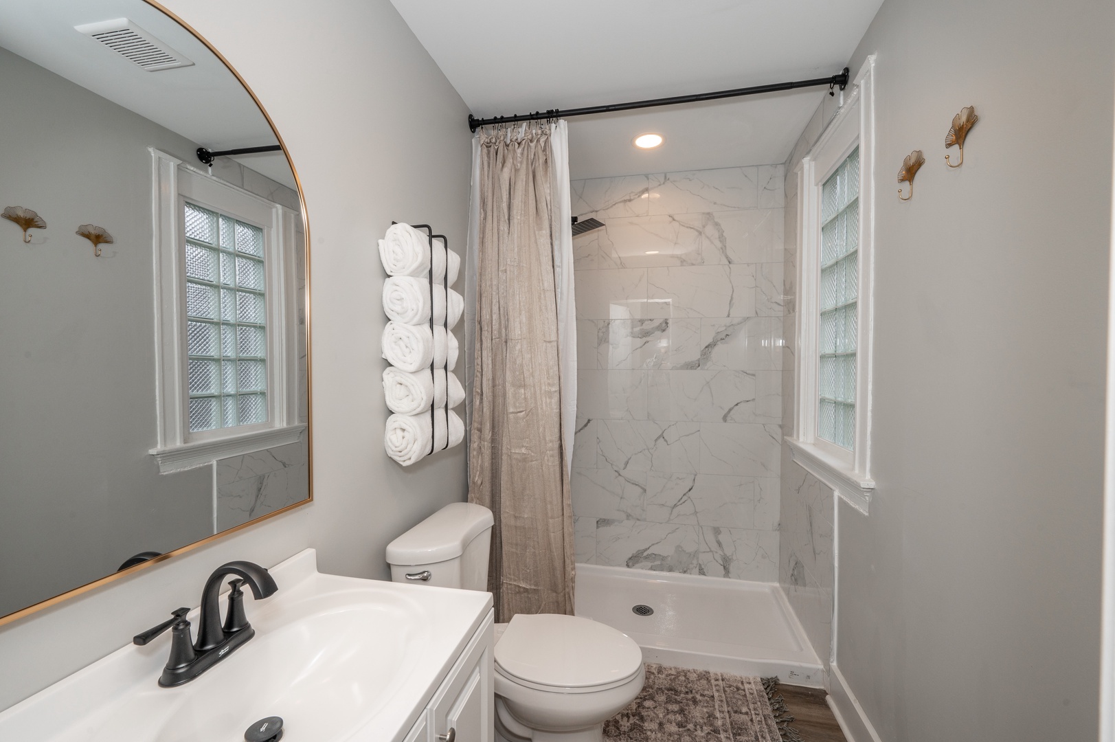 The full bathroom offers guests a single vanity & walk-in shower