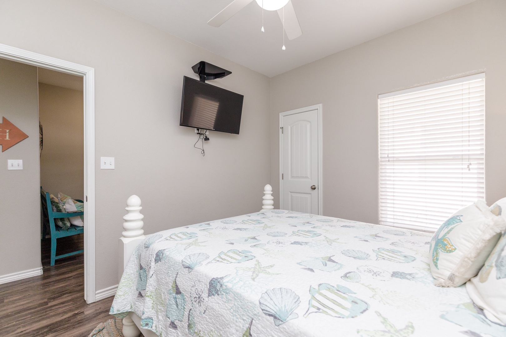 The 1st of 3 first-floor bedrooms offers a full bed, en suite bath, & Smart TV