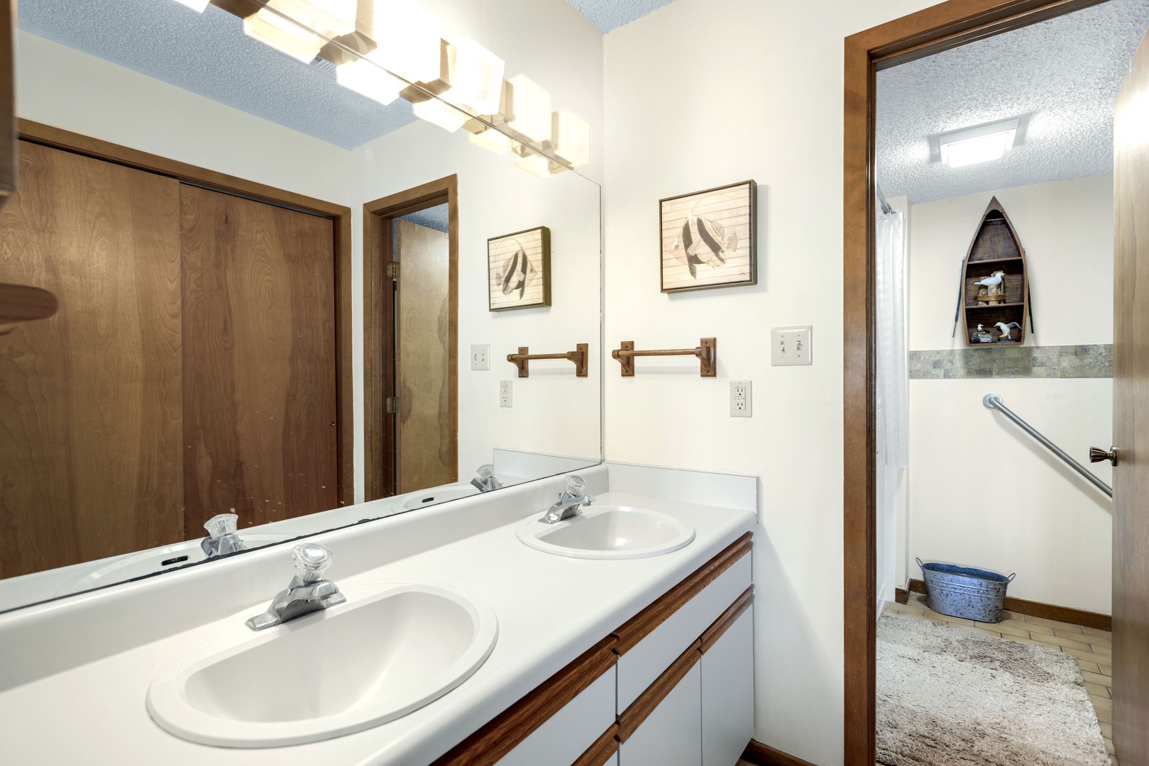Primary ensuite features double vanity, walk-in jet tub, and standing shower