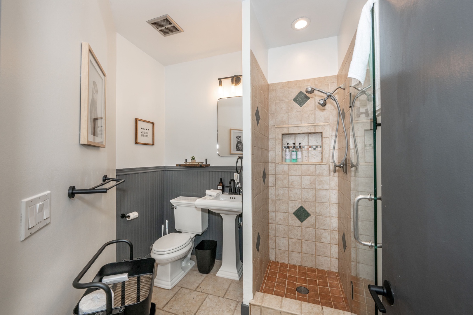 A pedestal sink & walk-in shower await in the third-floor full bathroom
