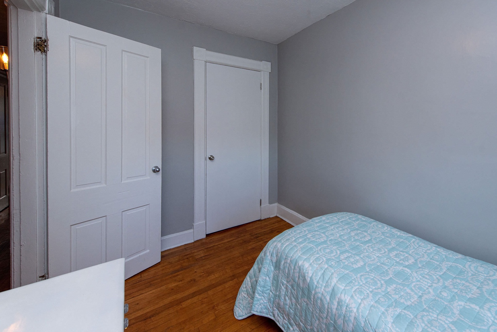 Suite 1 – The 3rd of 3 bedrooms offers a twin bed, dresser, & ceiling fan