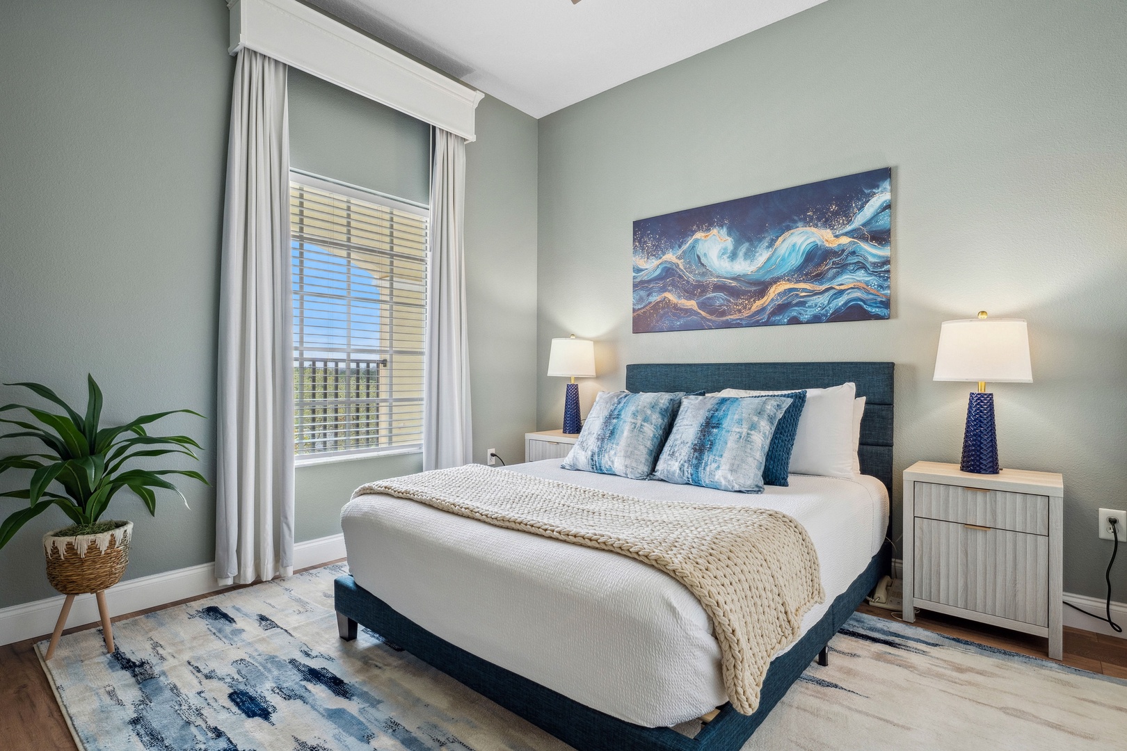 Recharge in the final bedroom, showcasing a regal queen bed & smart TV