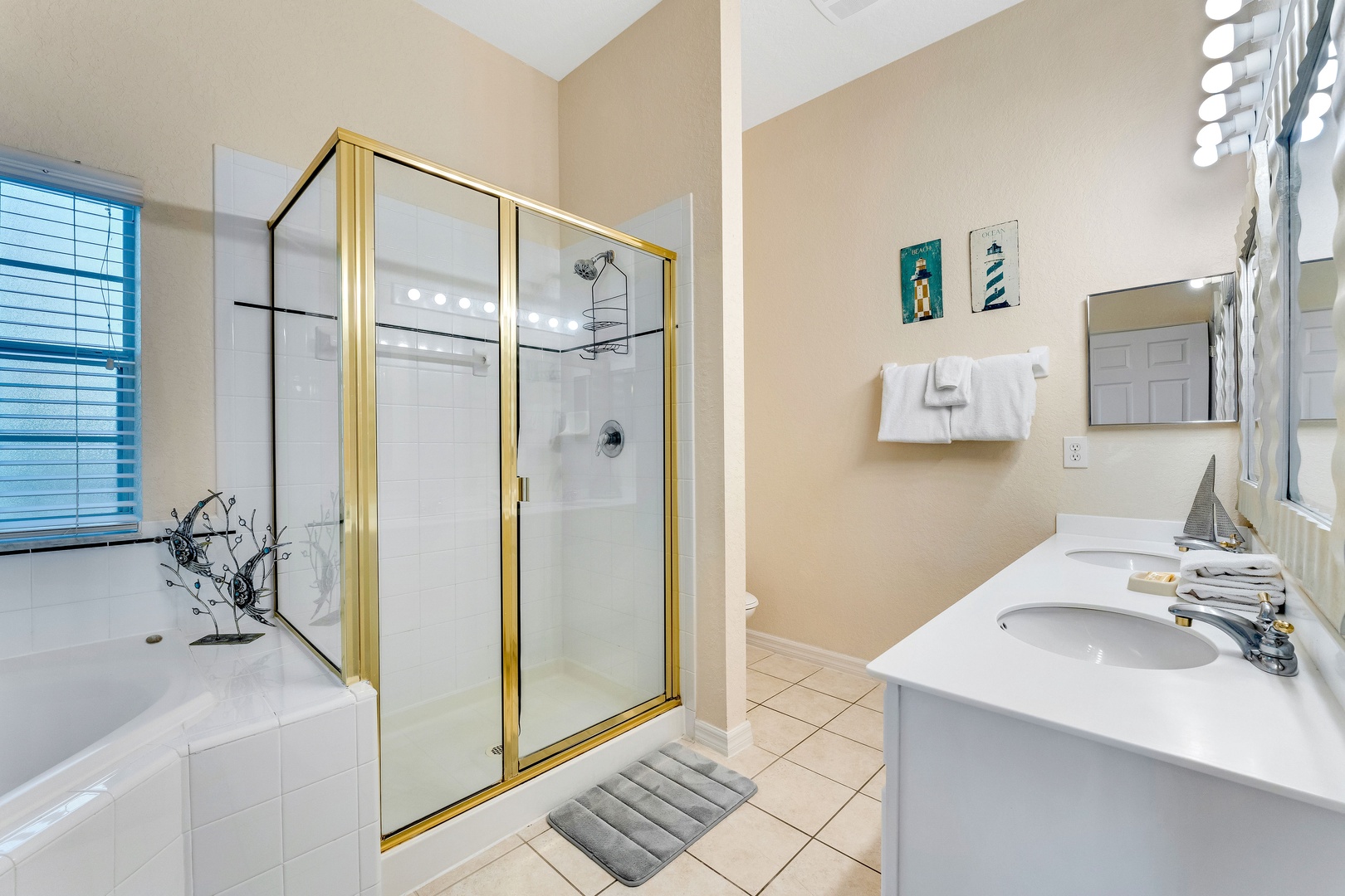 The king ensuite includes a dual vanity, glass shower, & luxe soaking tub