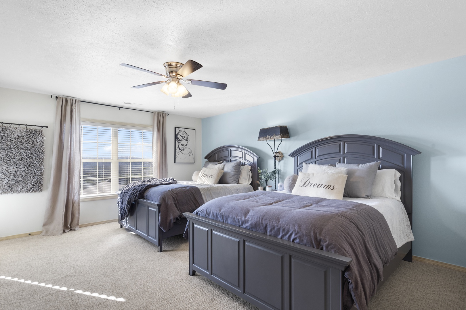The master suite features a pair of queen beds, private ensuite, balcony access, & TV