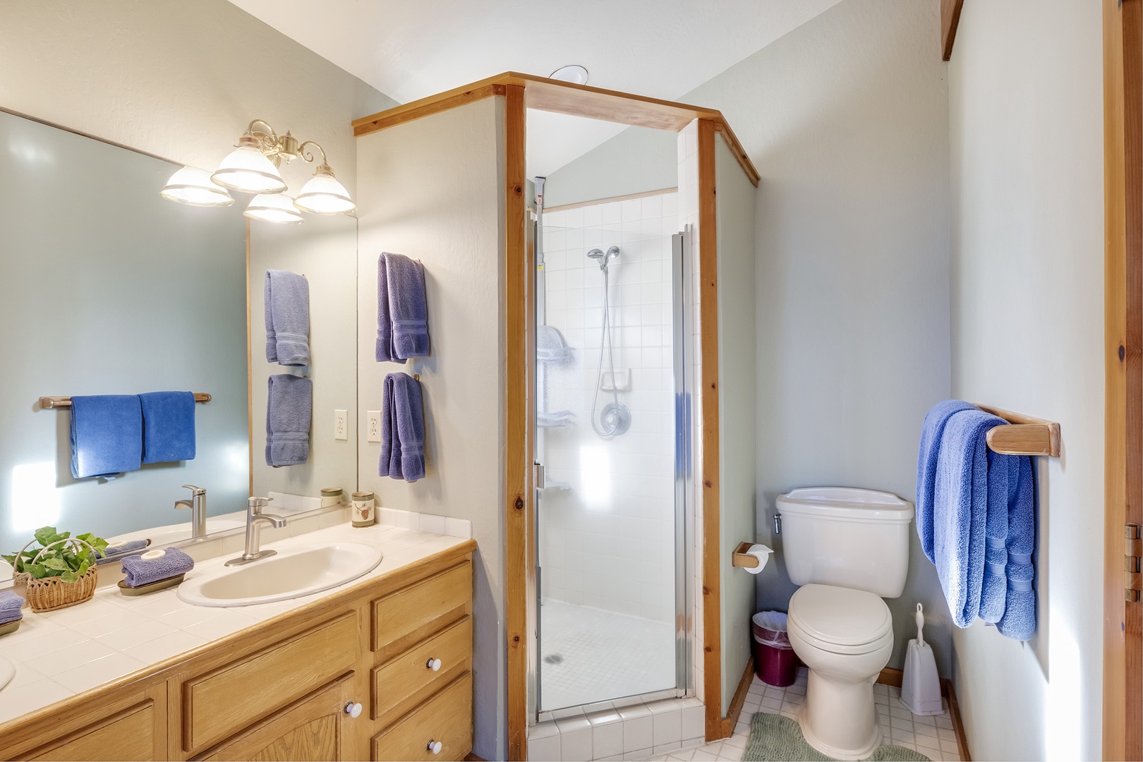 This ensuite bath features a double vanity, glass shower, and soaking tub