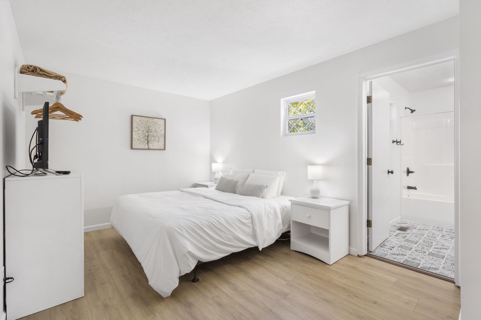 The final 2nd floor bedroom includes a king bed, Smart TV, & private en suite