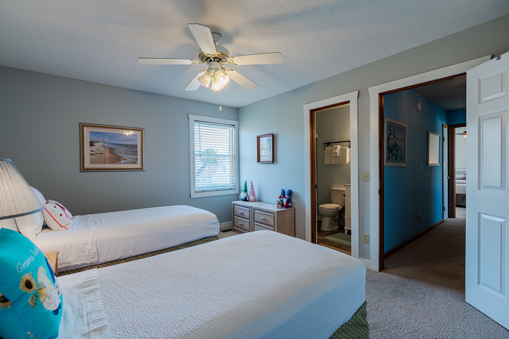 This serene double twin bed suite boasts a private ensuite with ceiling fan