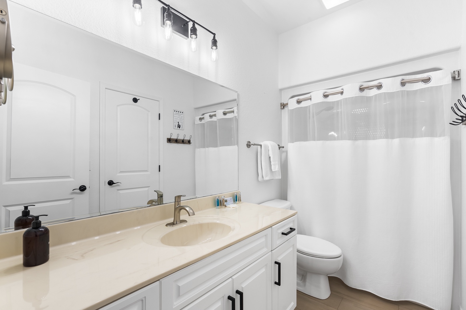 The bunk room ensuite offers an oversized single vanity and shower tub combo