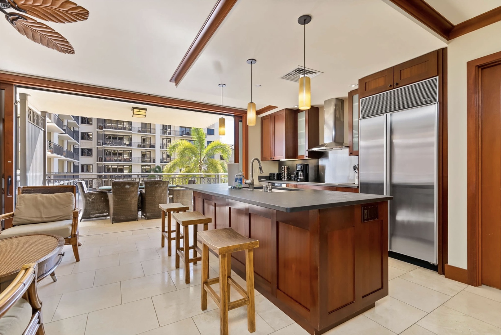 Kitchen with a large fridge and barstool seating at the island