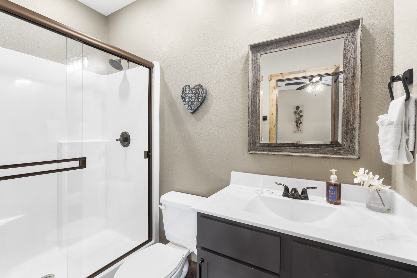 The third bedroom’s ensuite offers a single vanity & glass shower