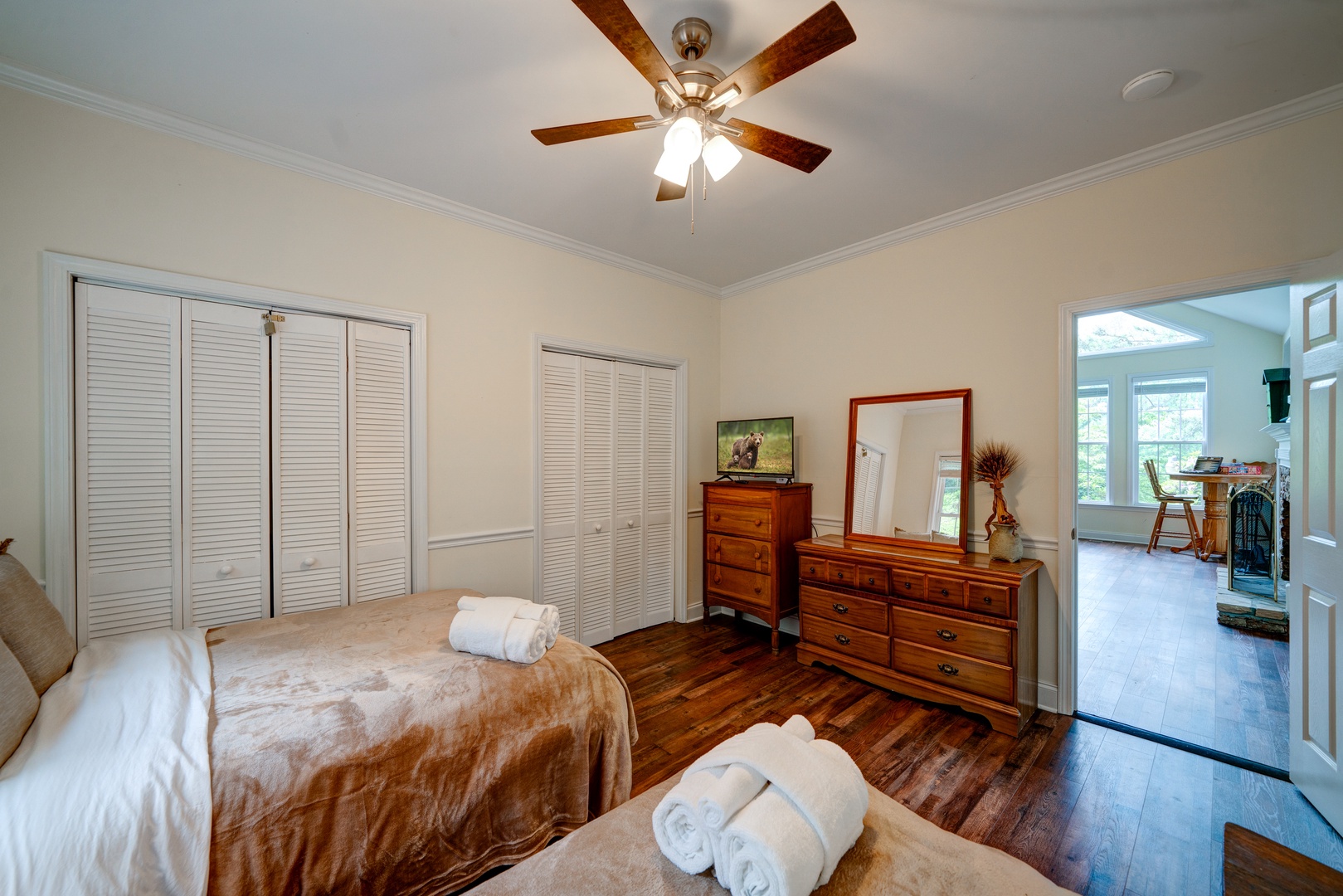 A pair of plush full-sized beds & a Smart TV awaits in this bedroom retreat