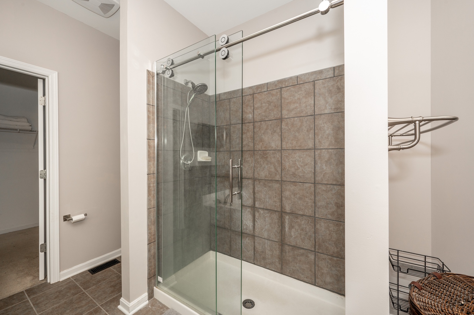 The 1st floor king en suite offers a chic double vanity, shower, & soaking tub