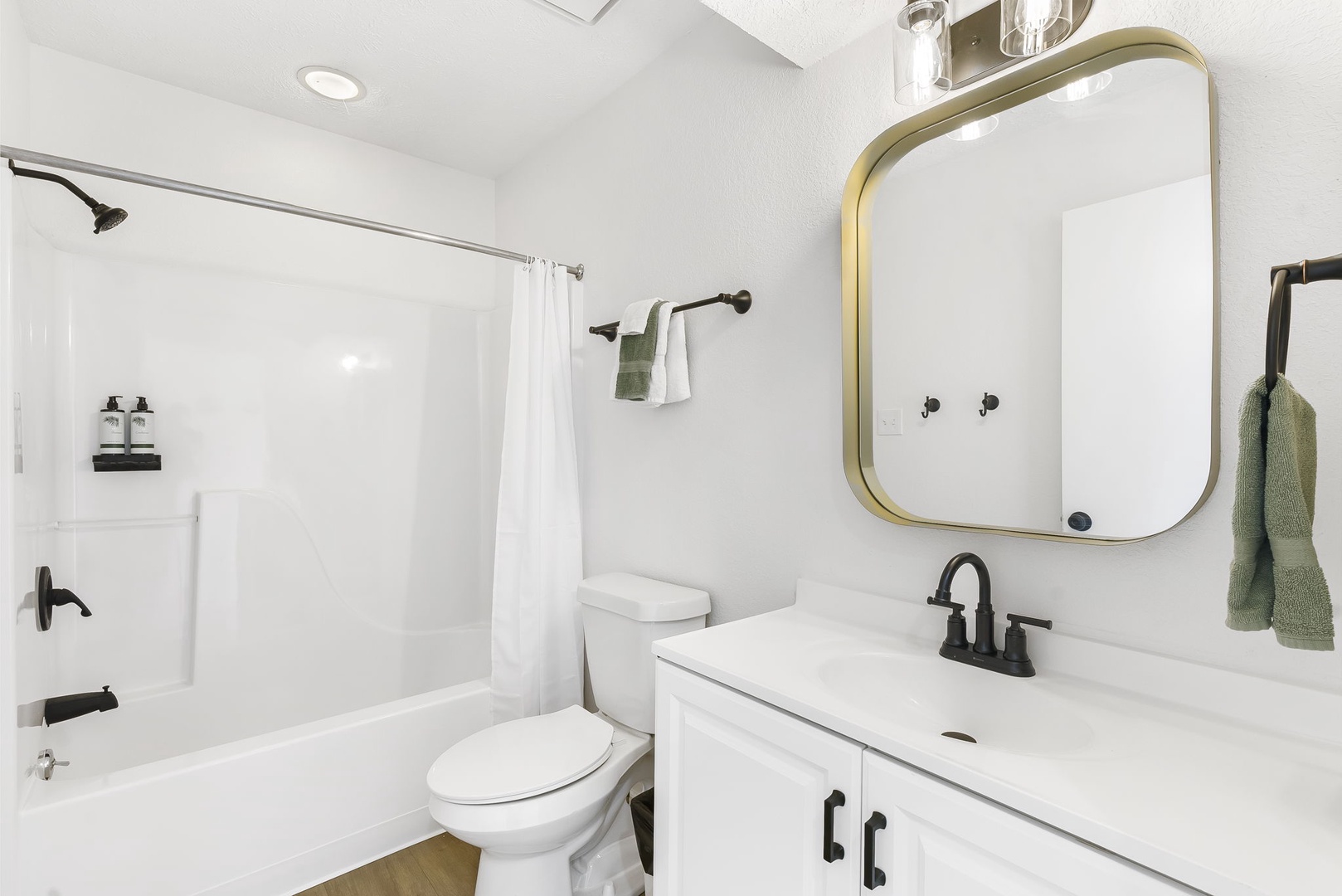 The 2nd floor hall bath offers a single vanity & shower/tub combo