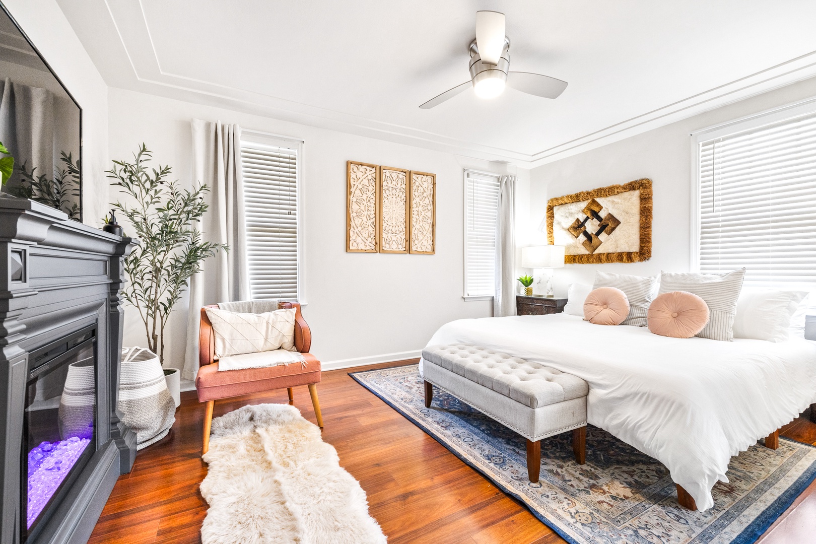 Bedroom 2 with king bed, TV, electric fireplace, and ensuite