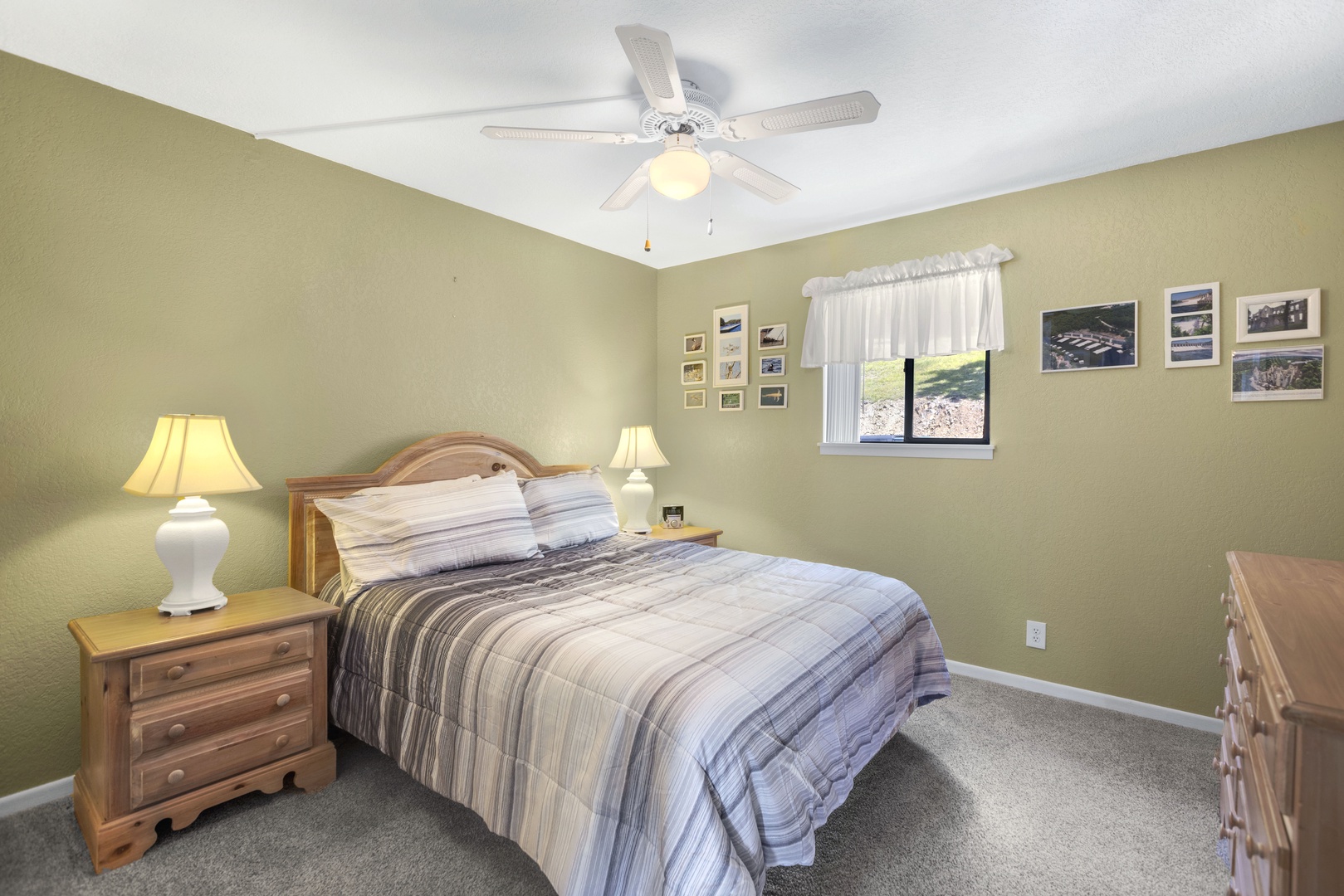 The master bedroom retreat showcases a plush queen bed, ceiling fan & smart TV