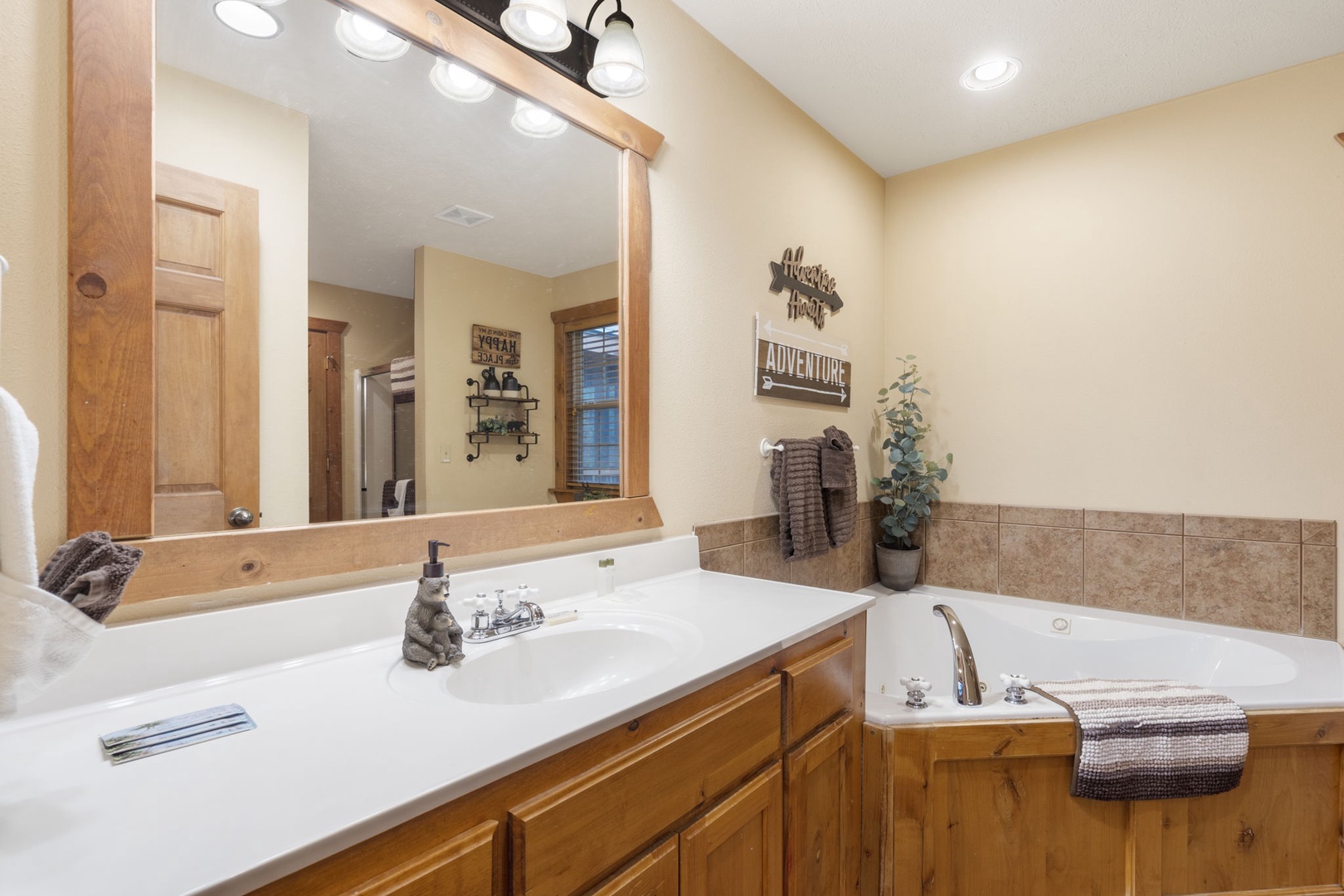 This king ensuite boasts a spacious vanity, glass shower, & luxurious jetted tub