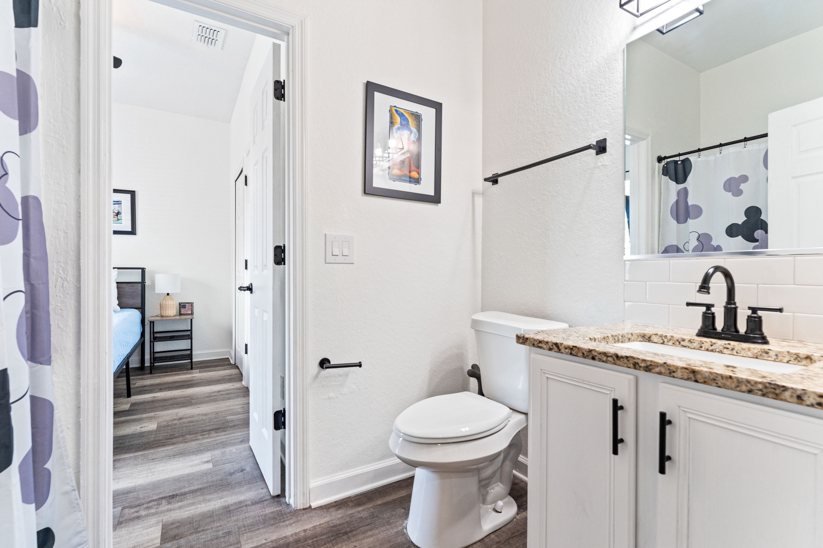 Prepare for the day in this ensuite, with a single vanity & shower/tub combo