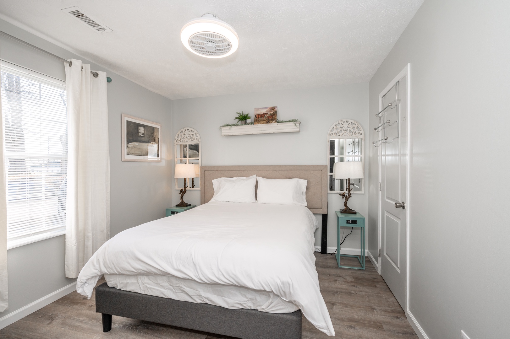 This serene bedroom retreat features a plush queen bed & Smart TV
