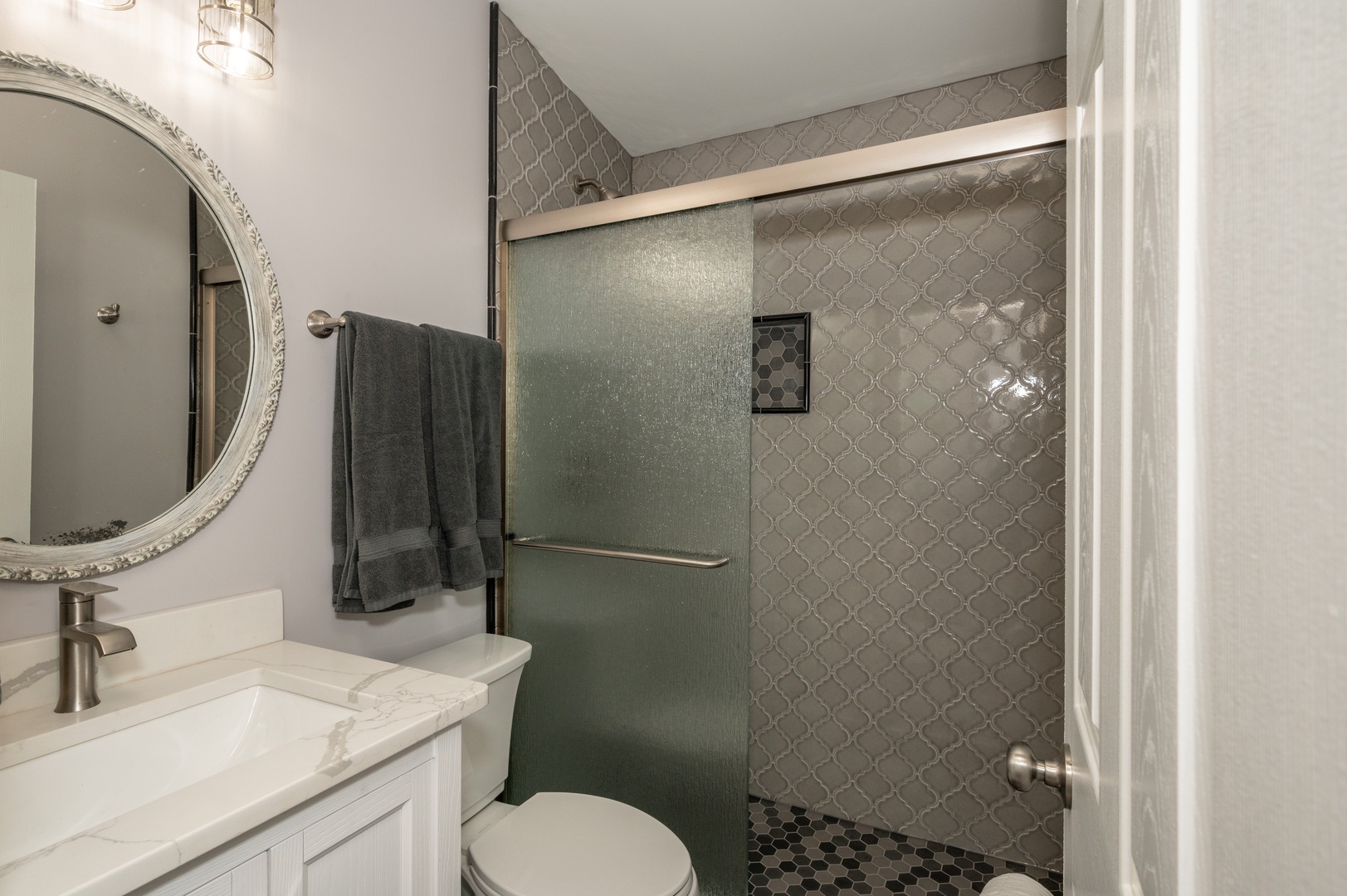 Apt 2 – The full bathroom includes an elegant single vanity & walk-in shower