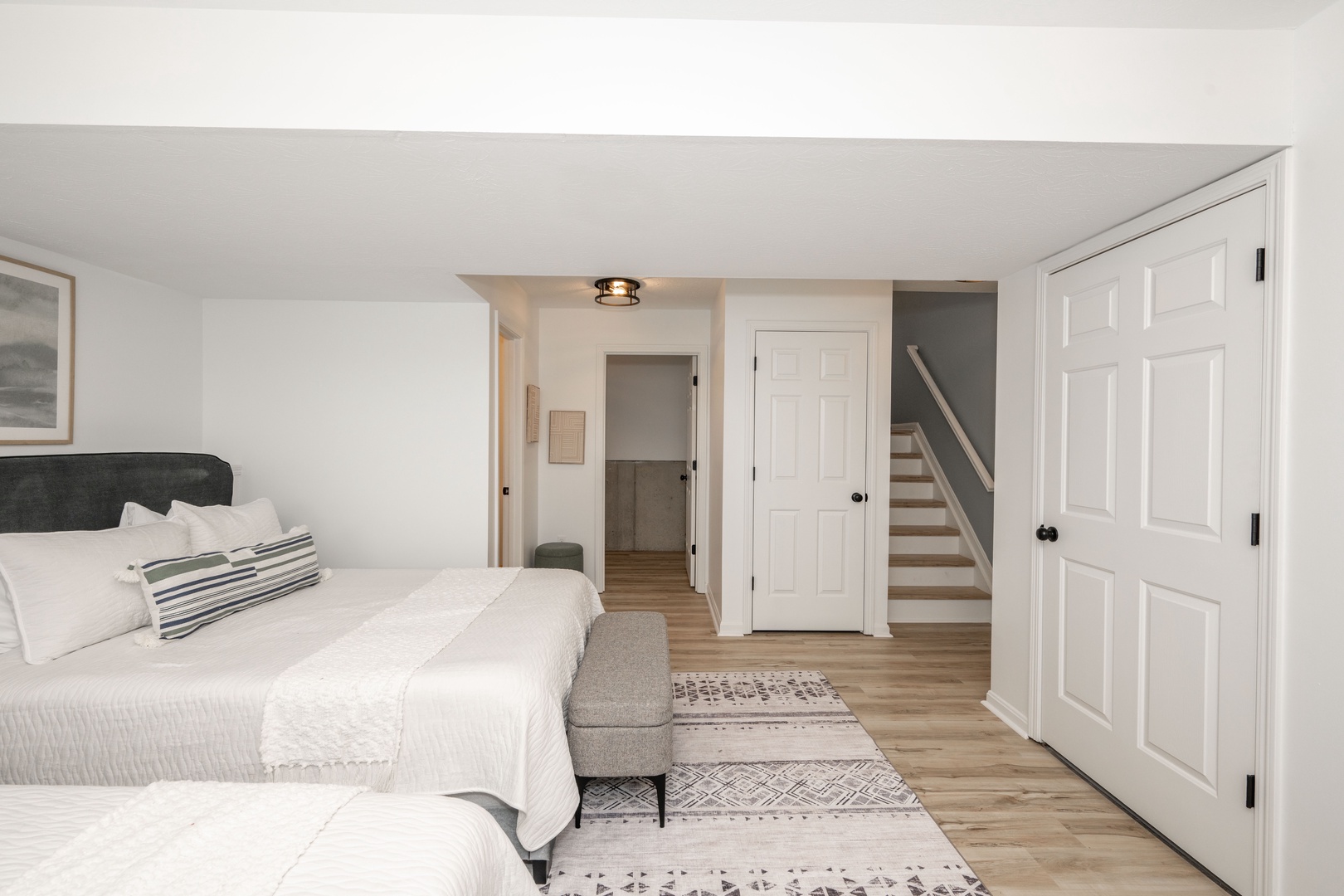 This private basement bedroom includes 2 queen beds & a half bath ensuite