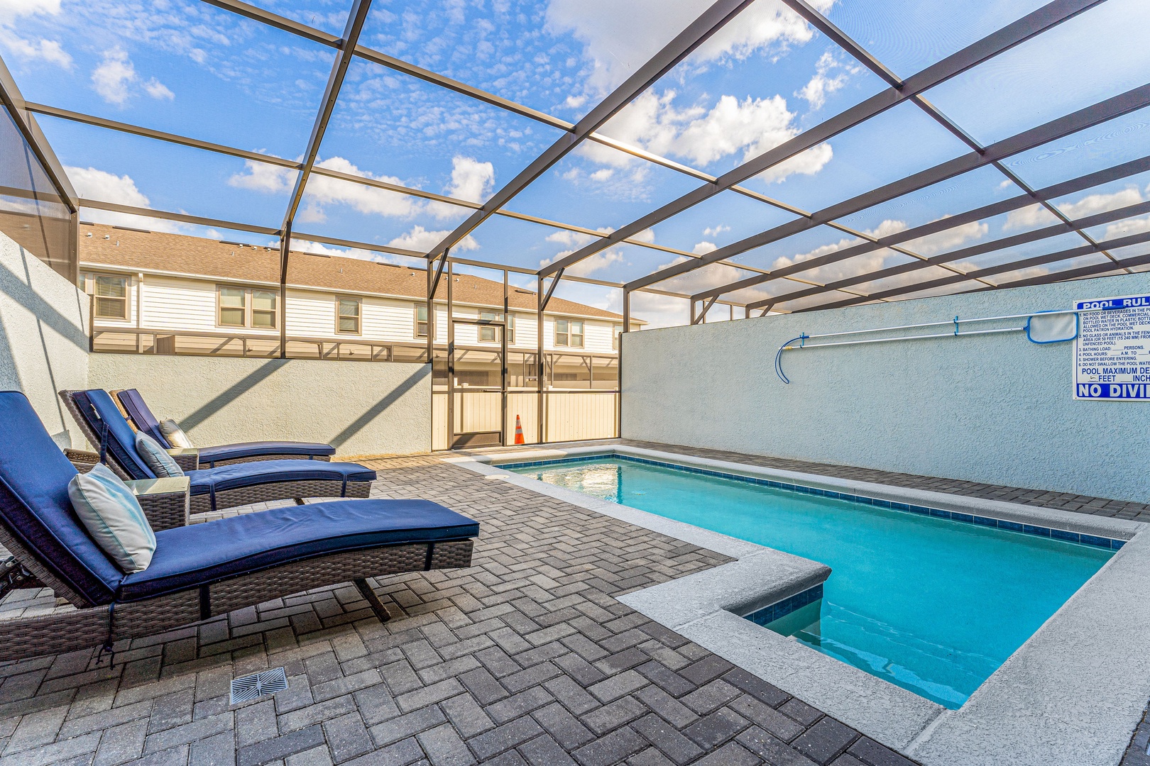 Poolside retreat under the lanai, complete with inviting lounge chairs