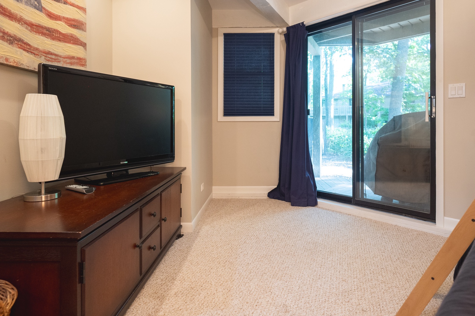 The second bedroom offers a twin-over-full bunkbed, twin trundle, Smart TV, & deck access