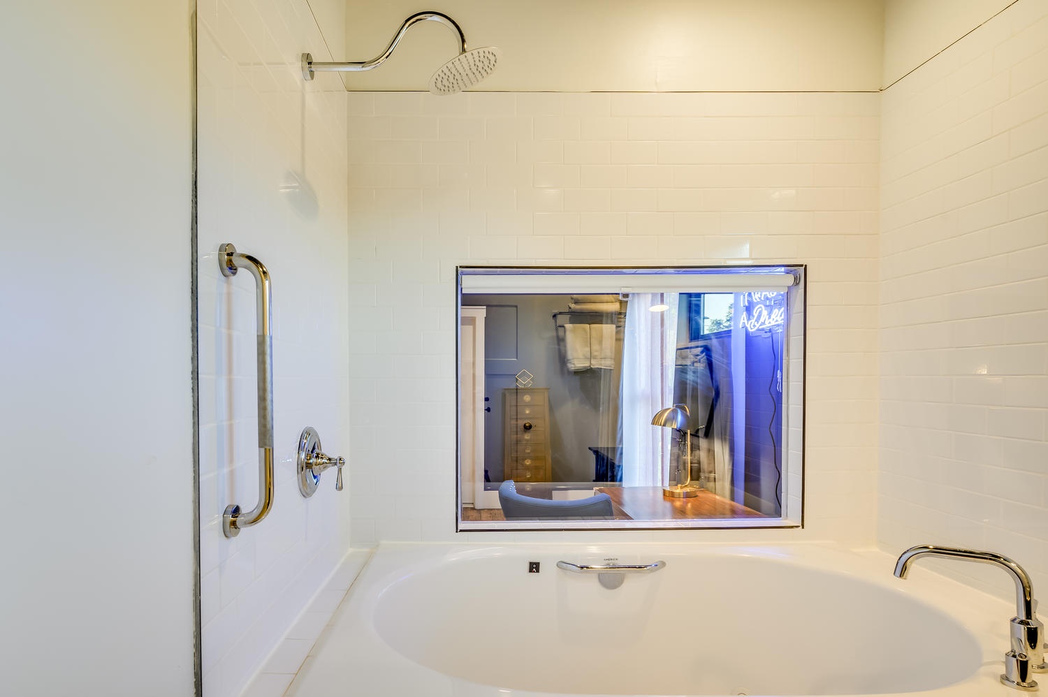 Suite 203 – The 2nd Floor Blue Mid-Century En Suite boasts a Single Vanity with makeup mirror & deep Soaking Tub with Shower