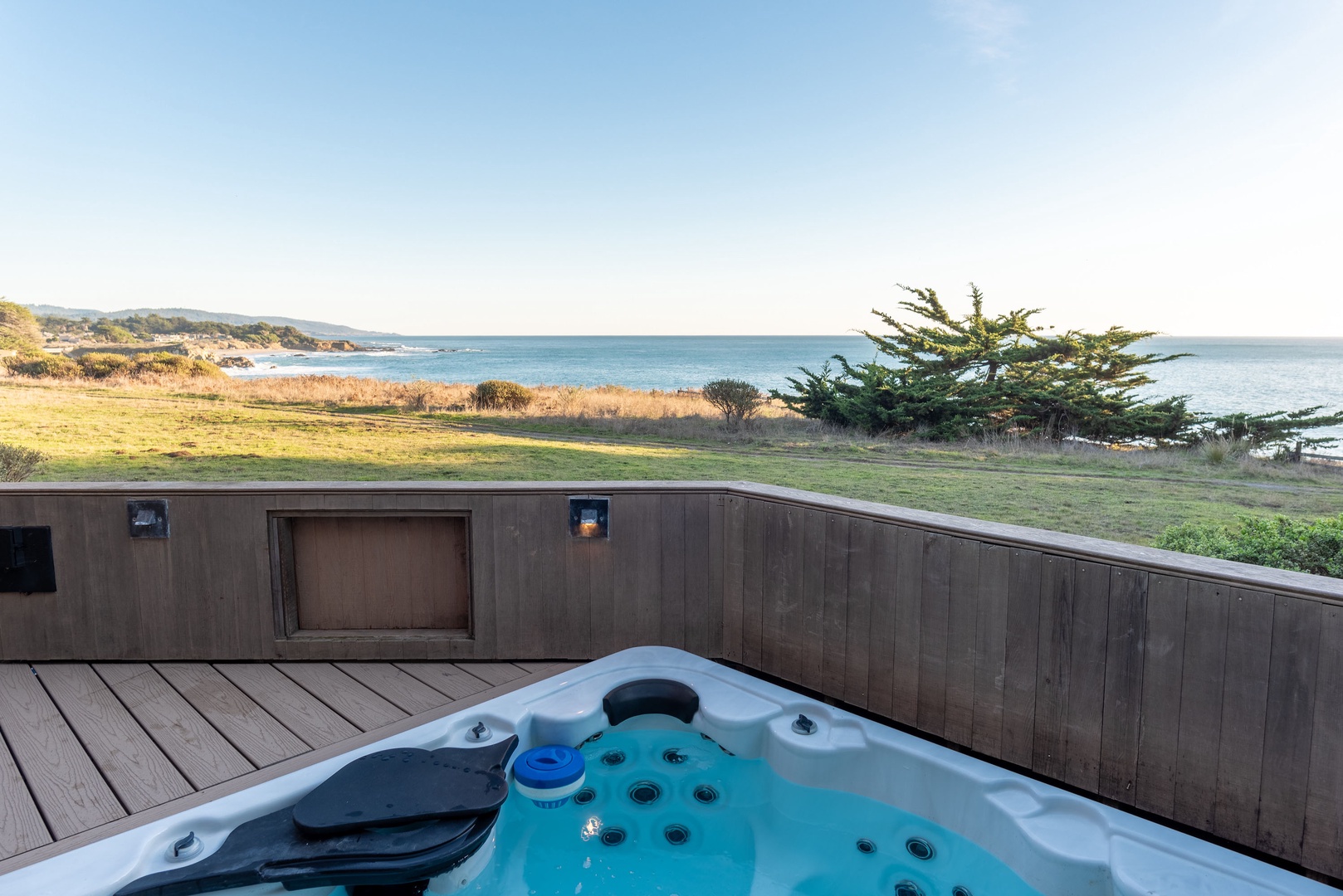 Private outdoor hot tub on deck with ocean views