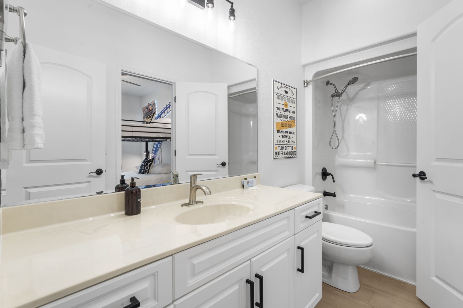 The bunk room ensuite offers an oversized single vanity and shower tub combo