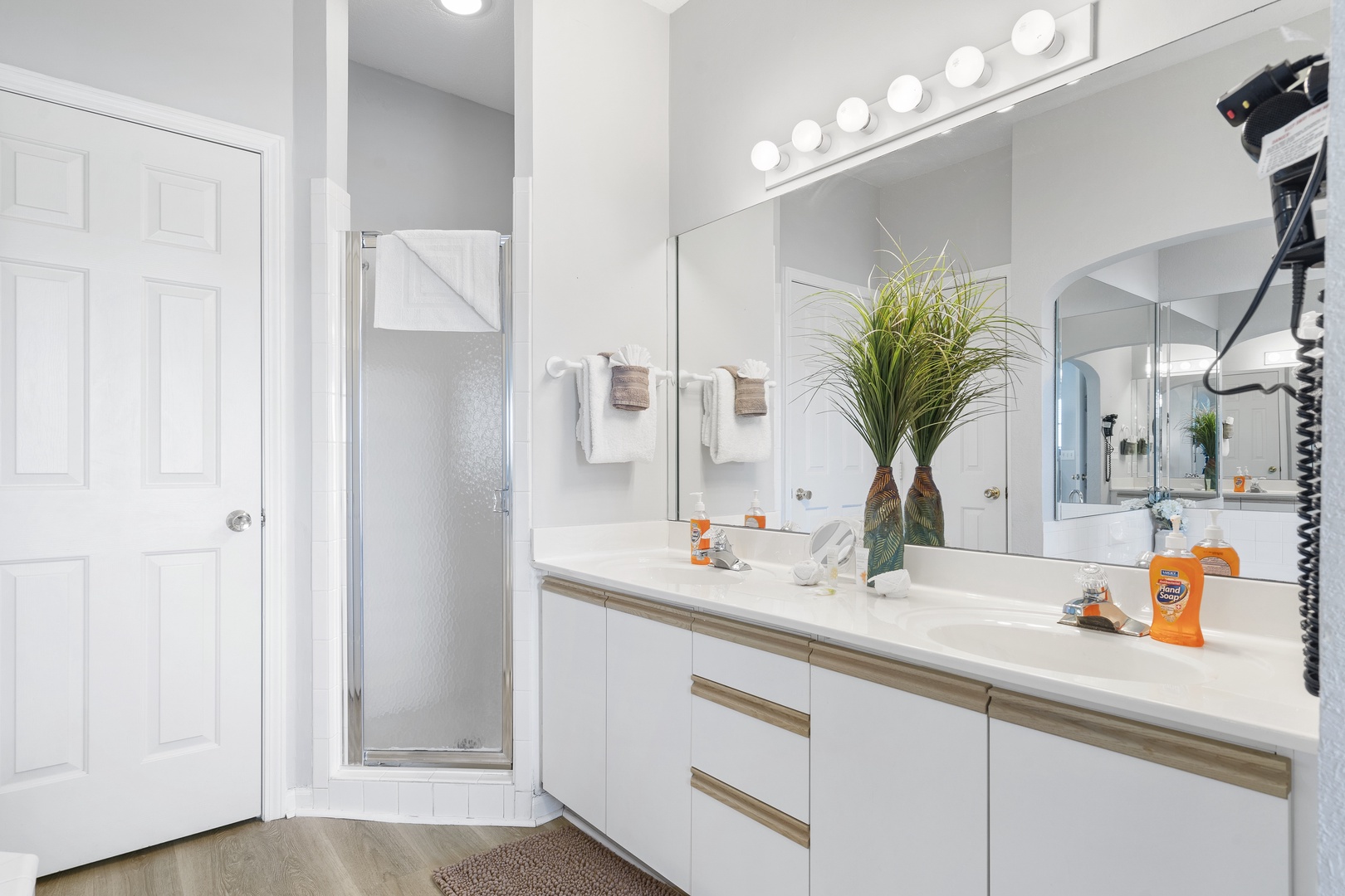 The king ensuite offers a double vanity, shower, & luxurious soaking tub