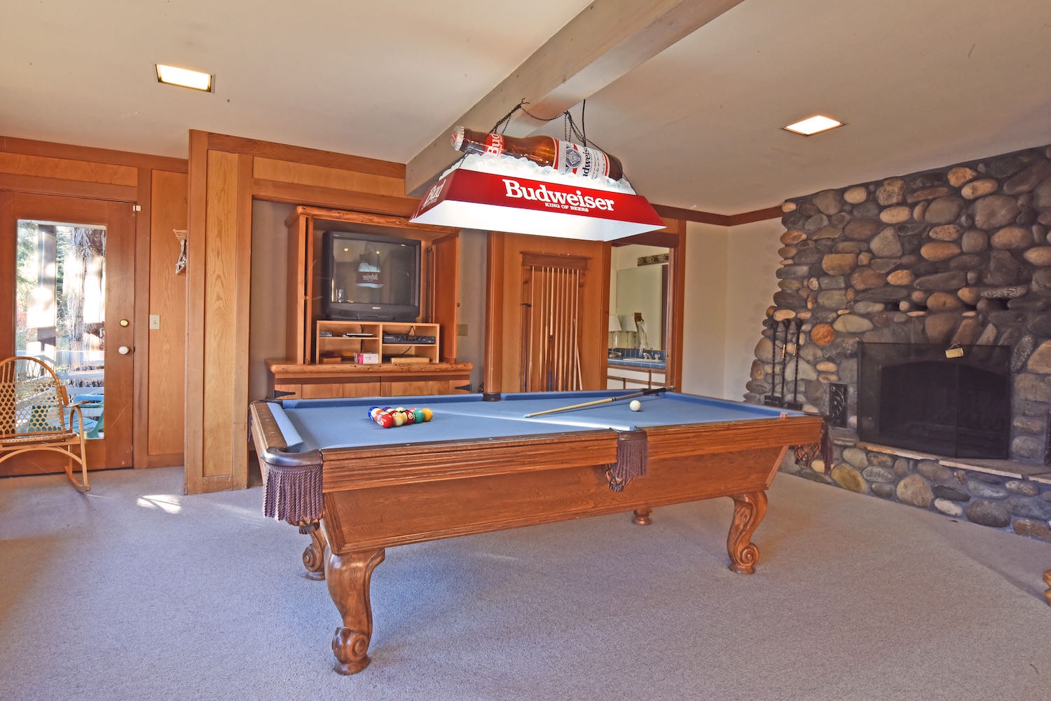 Downstairs game room pool table and fireplace