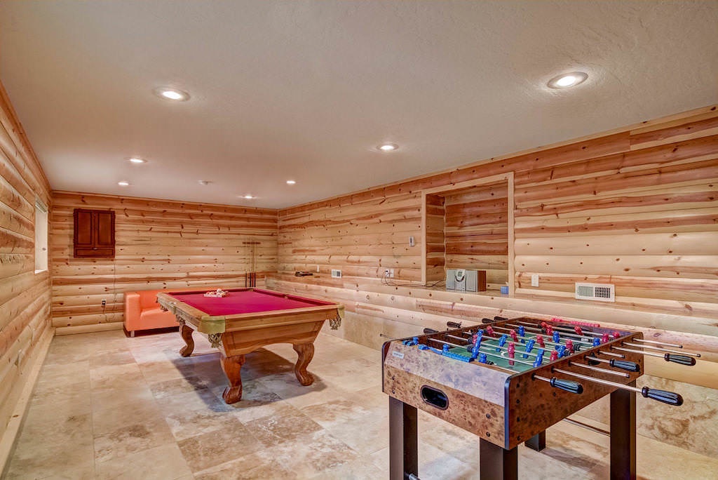 Game room with foosball table and pool table
