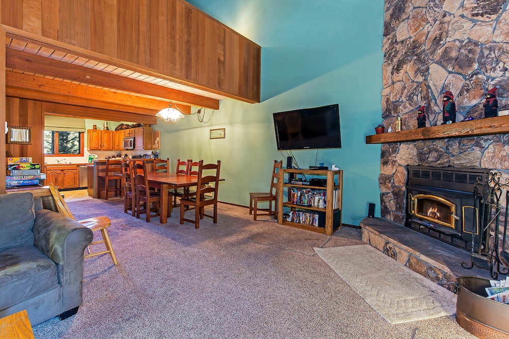 Living room w/ 40" flat screen TV, DVD player, board games, wood burning fireplace