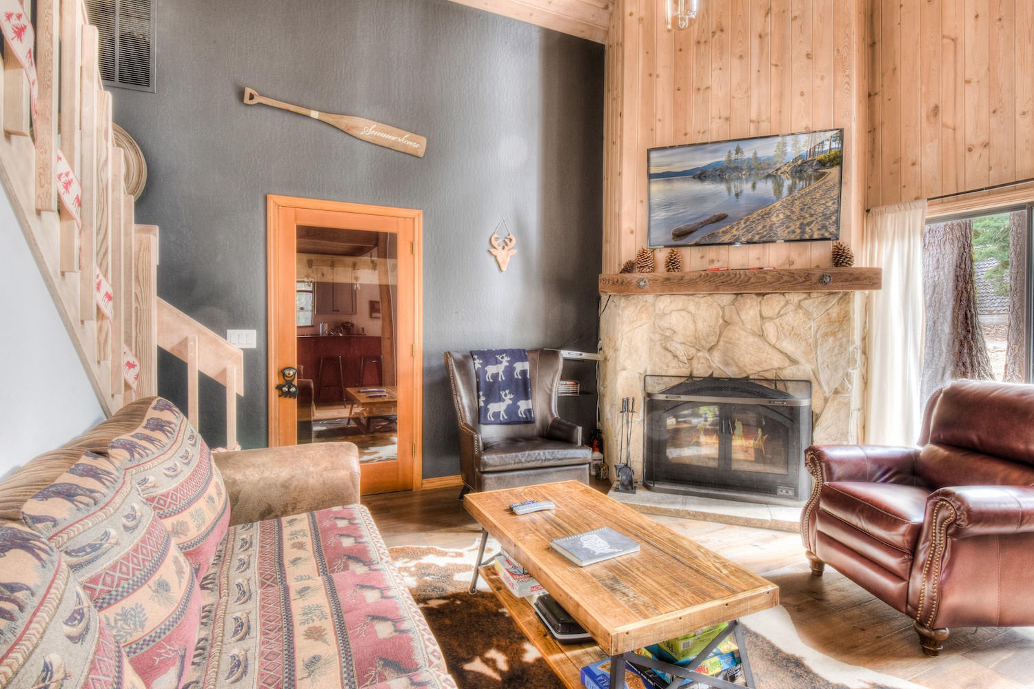 Living room w/ Smart TV (Roku, Amazon FireStick, Apple) & wood fireplace