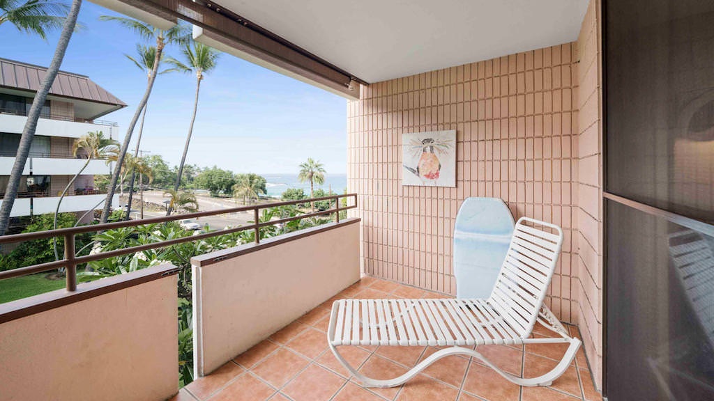 Patio lounge chair and beach equipment on pink tiled lanai