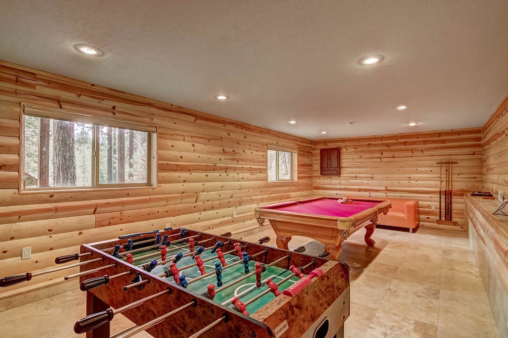 Game room with foosball table and pool table