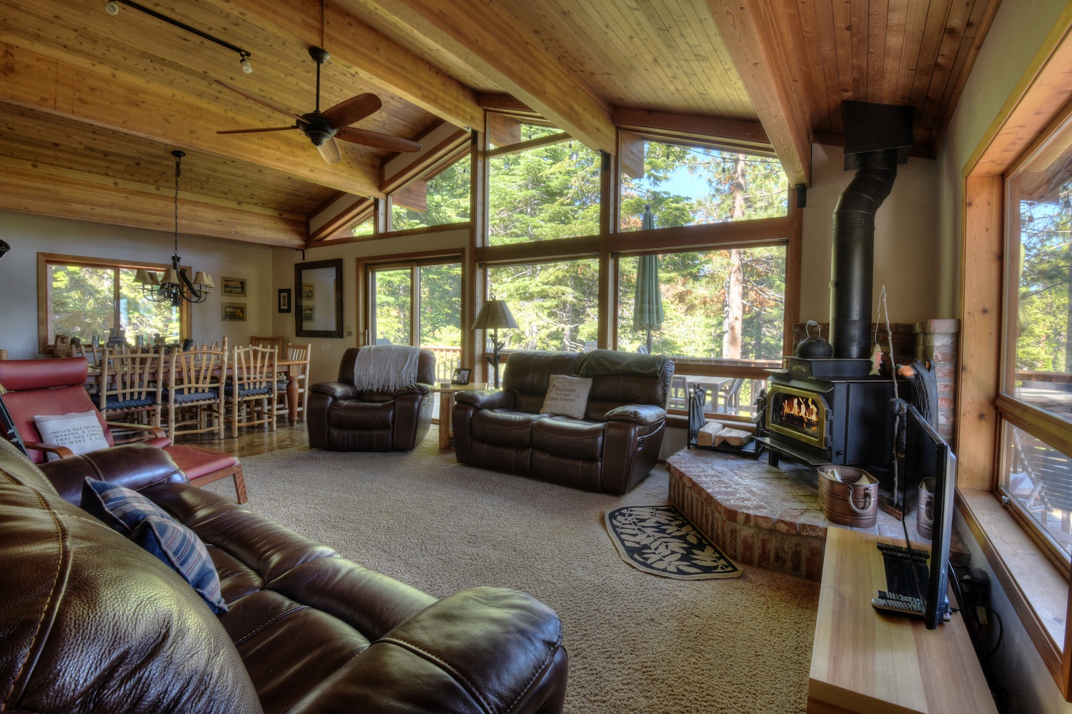 Living room with floor to ceiling windows and wood fireplace