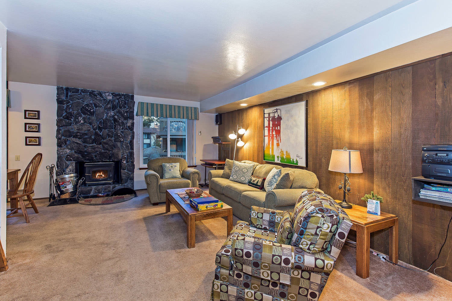 Living room w/ sofa sleeper, wood burning fireplace, TV