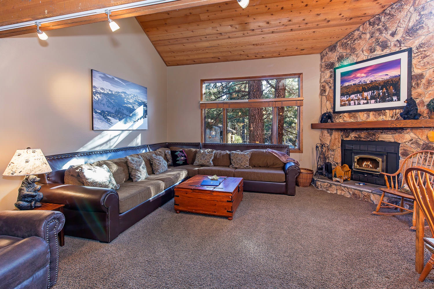 Living room w/ flat screen TV, BluRay DVD player, wood burning fireplace and board games