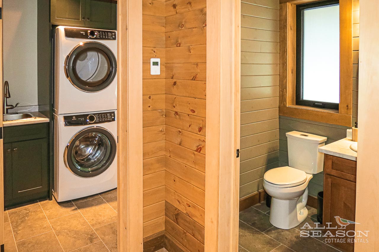 Enjoy the convenience of full-size washer and dryer plus a modern bathroom with rustic wood accents during your stay.