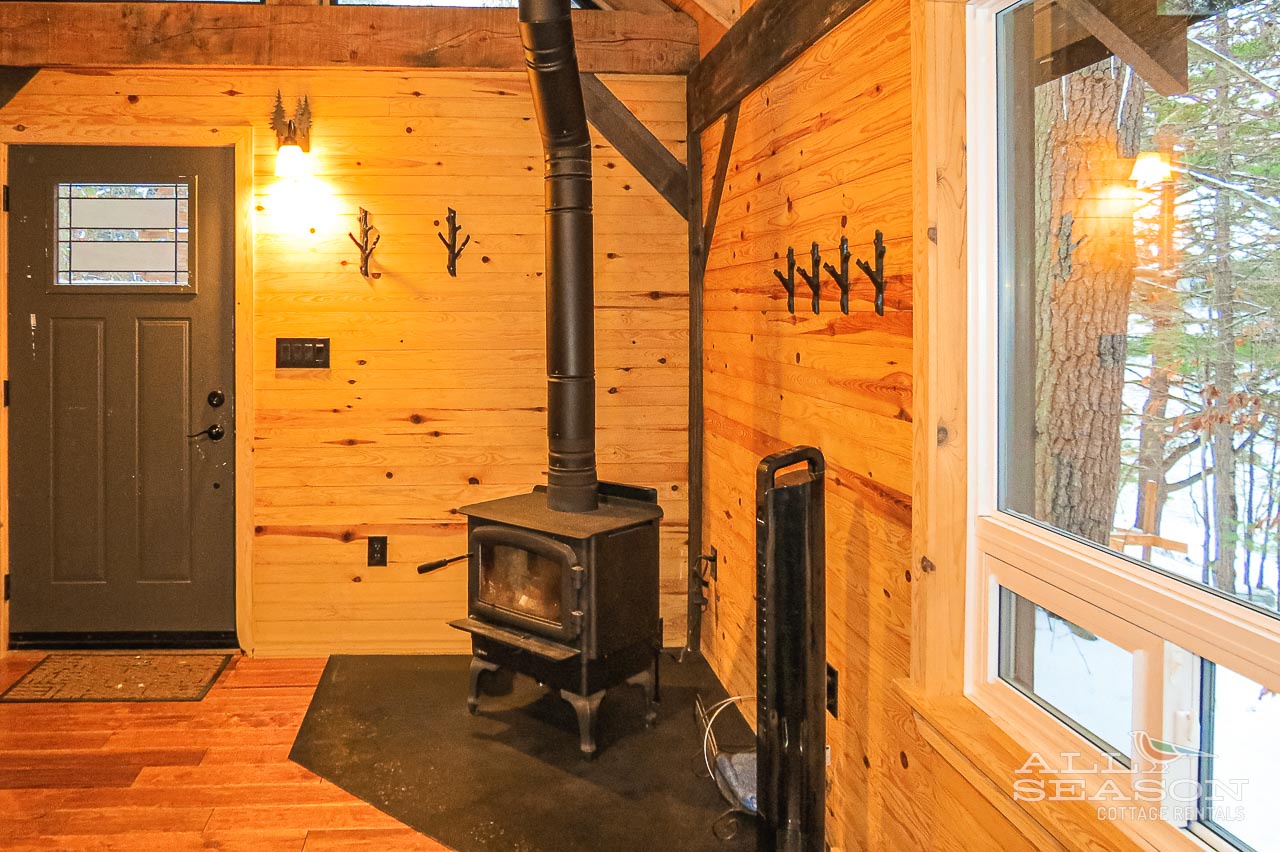 Cozy up by your wood-burning stove while snow falls outside your rustic cabin retreat.